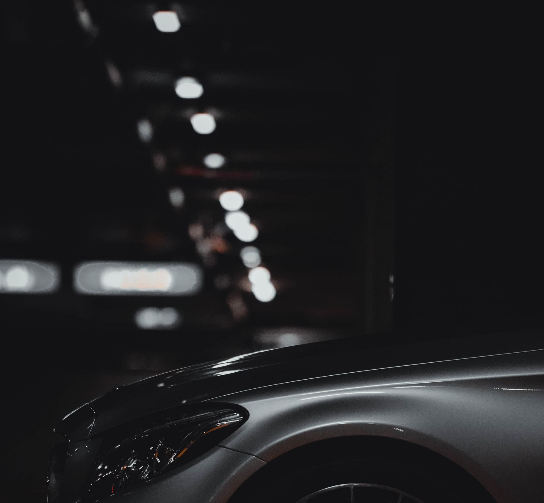 Silver car in a dark parking garage